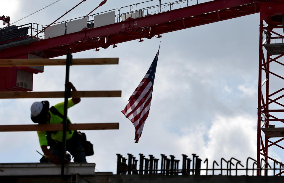 LOS ANGELES, CALIFORNIA - JANUARY 25: An American flag flies from a crane as construction worker helps build a mixed-use apartment complex which will hold over 700 units of apartment housing and 95,000 square feet of commercial space on January 25, 2024 in Los Angeles, California. Economic data from the Commerce Department released today showed that U.S. economy expanded 3.1 percent in 2023, shaking off inflation fears and making the U.S. the fastest growing advanced economy in the world in 2023. (Photo by Mario Tama/Getty Images)