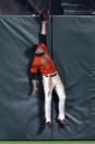 San Francisco Giants center fielder Austin Slater leaps in vain for a two-run home run by San Diego Padres' Trent Grisham's during the sixth inning of a baseball game Friday, May 7, 2021, in San Francisco. (AP Photo/D. Ross Cameron)