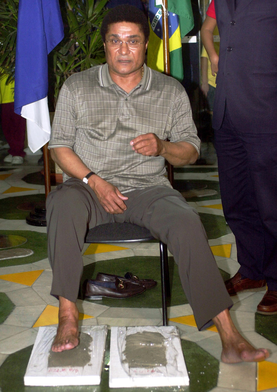 FILE - In this July 21, 2004 file photo, Portuguese soccer legend Eusebio Ferreira da Silva leaves his footprint in the Brazilian Hall of Fame at Maracana soccer stadium, Rio de Janeiro, Brazil. Dozens of former stars, including Pele and Garrincha, are remembered in the gallery. Eusebio, the Portuguese football star who was born into poverty in Africa but became an international sporting icon and was voted one of the 10 best players of all time, has died of heart failure aged 71, Sunday, Jan. 5, 2014. (AP Photo/Renzo Gostoli, File)