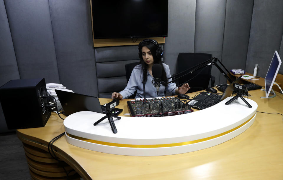 Palestinian journalist Rewaa Mershid works at the studio of ZMN FM radio station in Gaza City, Thursday, May 6, 2021. Mershid, a 26-year-old reporter for a local radio station, was with colleagues filming at a privately owned farm near the heavily guarded Gaza frontier on April 25 when two members of a Hamas-run border patrol approached and asked them to identify themselves. (AP Photo/Adel Hana)