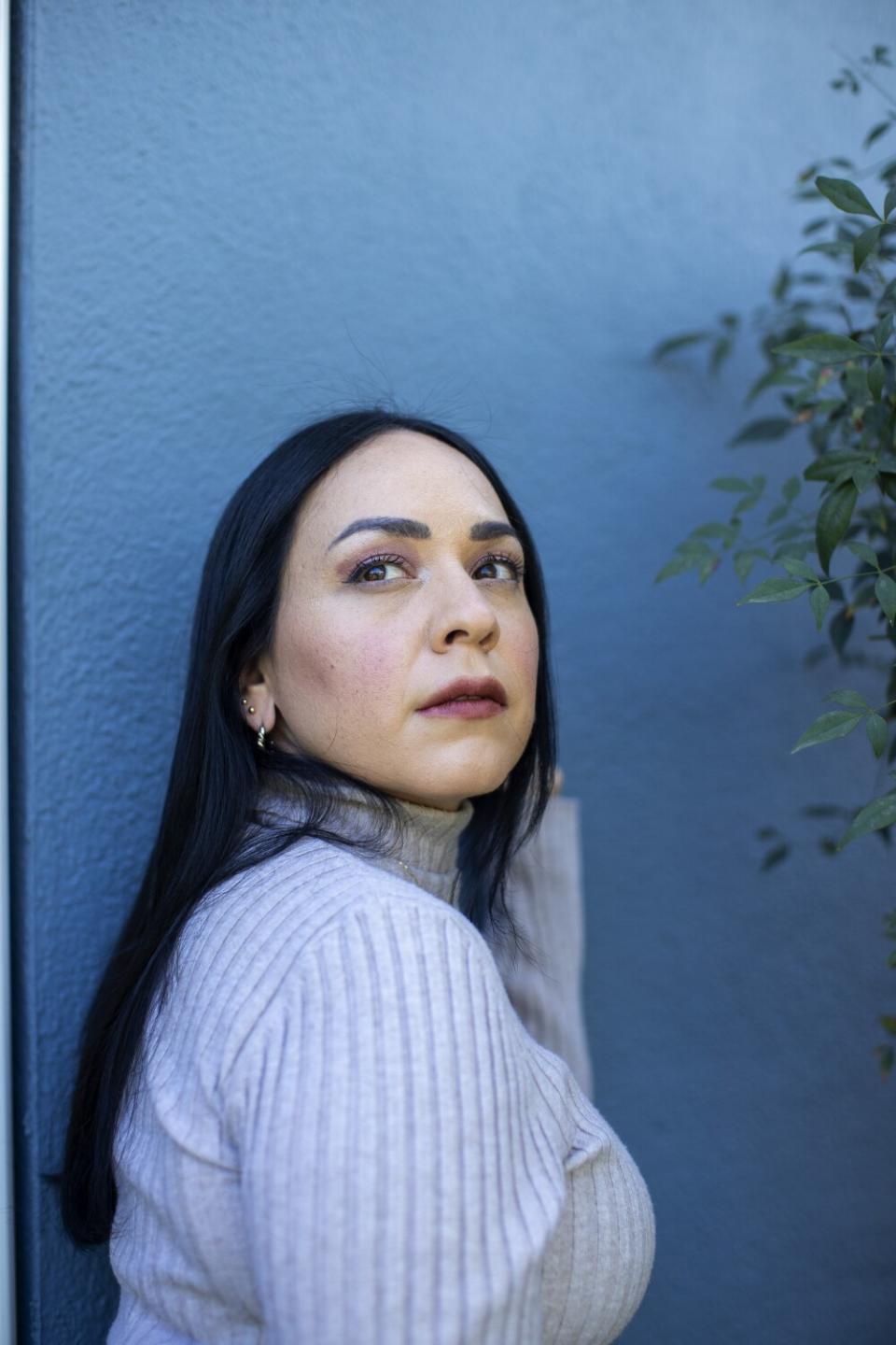 A portrait of Carla Morrison against a blue background