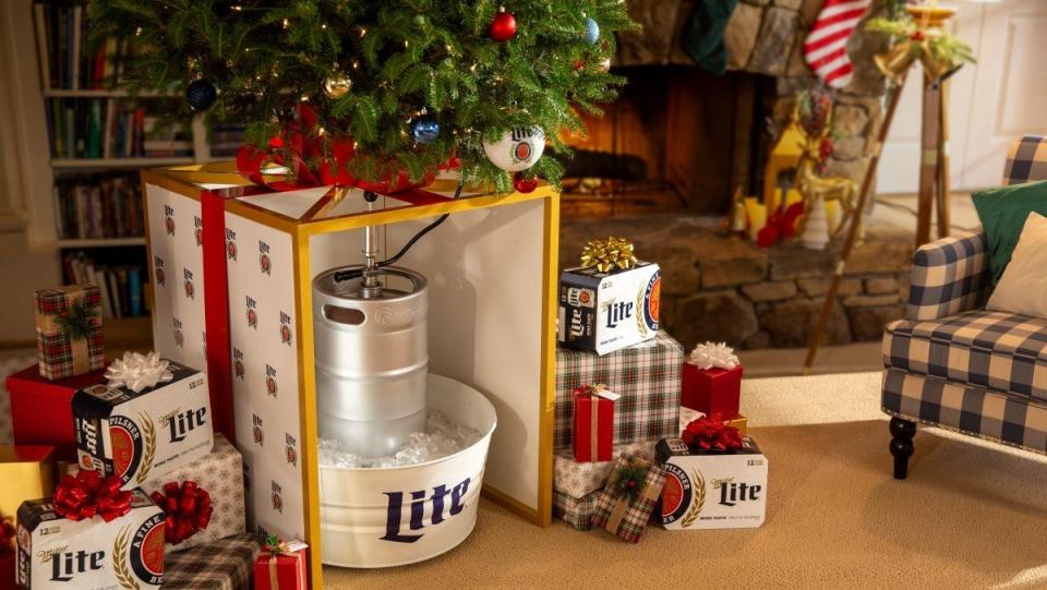 A living room decorated for Christmas with a tree stand that houses a keg of Miller Lite