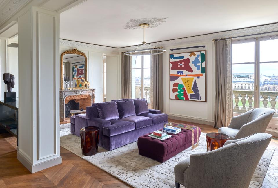 The main salon, with gorgeous views on the Invalides, is flooded with light. The space is anchored by a 1990 painting from American artist Shirley Jaffe. The work was purchased specifically for this wall and, Wood shares, “allowed for the opportunity to add some playfulness into what could otherwise be a very serious space.” The custom carpet with geometric elements is Donghia and the custom curtains are Rubelli with trim by Houlès, fabricated by Delapartdefred. Other elements include an antique mirror from the Paris Flea Market above the mantel, with a horse by Charles Paris. Scottie Stools by Pinto Paris and a bronze bust by Modigliani on a custom lacquer console by Laure Caye Decoration.