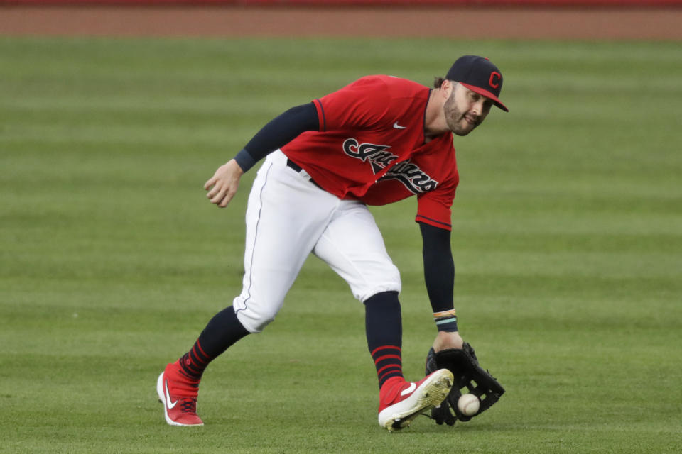 Cleveland Indians' Tyler Naquin fields a single hit by Chicago Cubs' Javier Baez (9) in the fifth inning in a baseball game, Wednesday, Aug. 12, 2020, in Cleveland. (AP Photo/Tony Dejak)