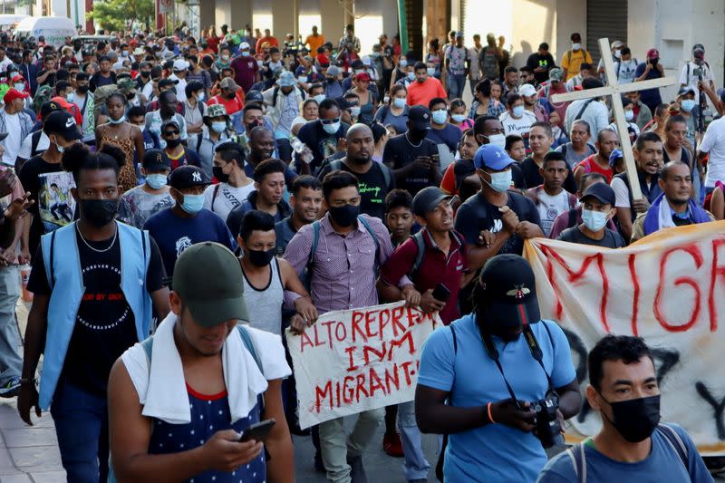 Migrants walk in a caravan headed to the Mexican capital to apply for asylum and refugee status