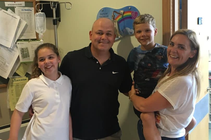 Stephen ringing the bell to mark the end of his treatment with his family