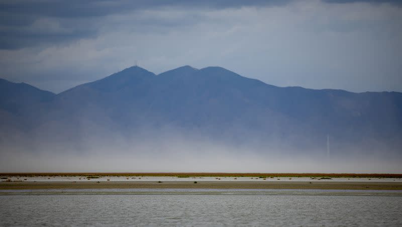 Dust blows off the dry lake bed of the Great Salt Lake as seen from Farmington Bay on Aug. 19, 2022.