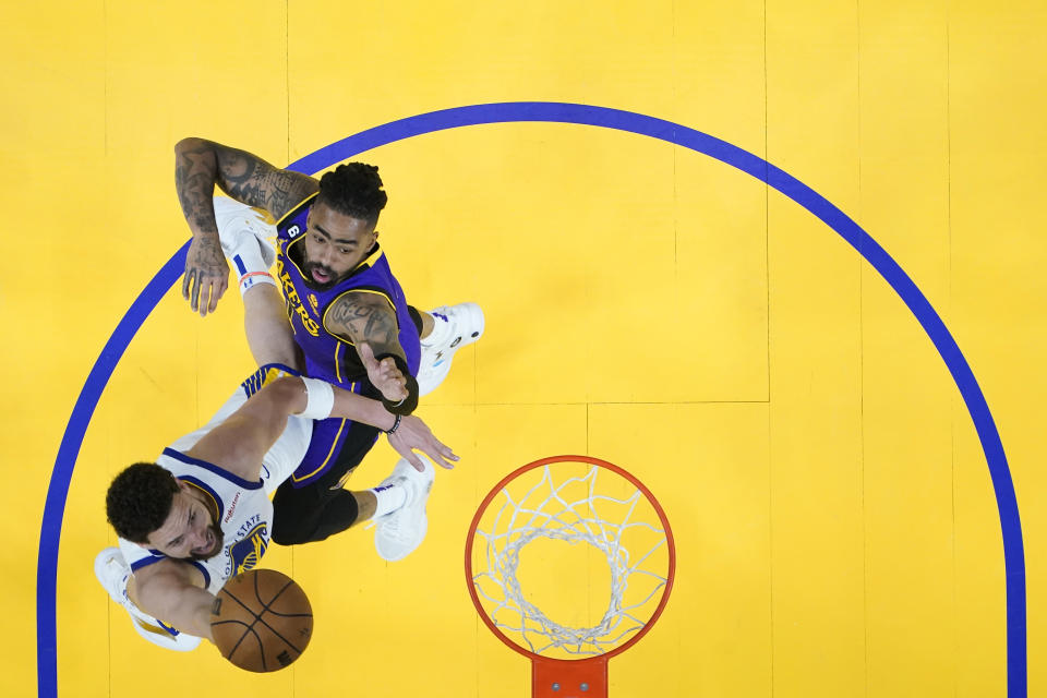 Golden State Warriors guard Klay Thompson, left, shoots while defended by Los Angeles Lakers guard D'Angelo Russell during the second half of Game 2 of an NBA basketball Western Conference semifinal game, Thursday, May 4, 2023, in San Francisco. (AP Photo/Godofredo A. Vásquez)