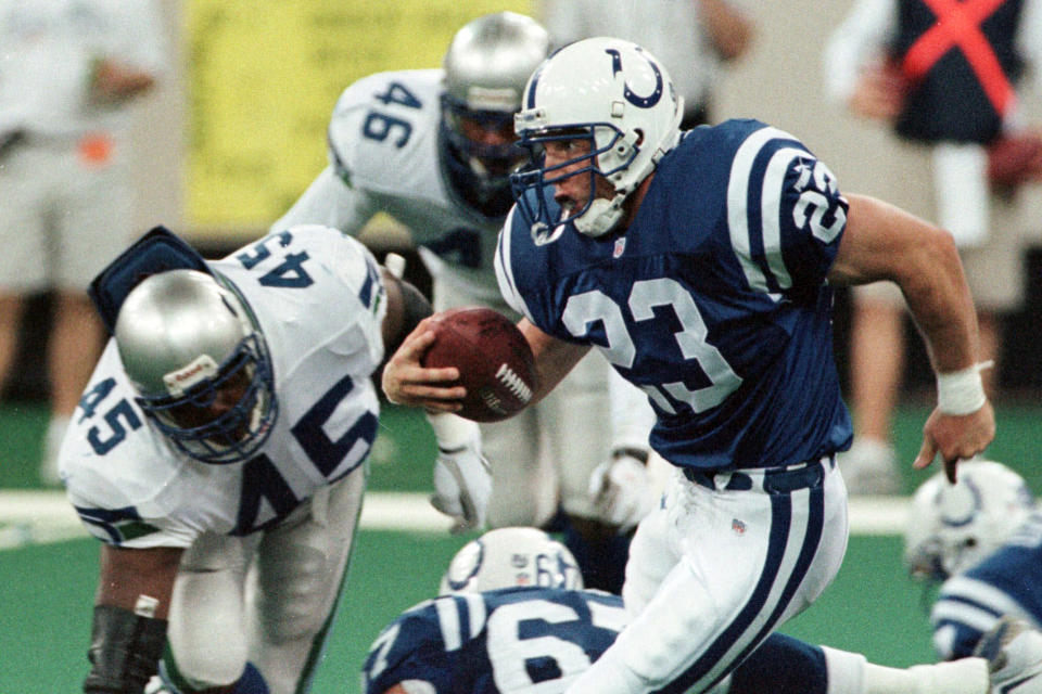 FILE - In this Sept. 2, 1999, file photo, Indianapolis Colts running back Keith Elias (23) runs by Seattle Seahawks' Sedrick Clark (45) and Scott Fields (46) to pick up a first down on the Colts' final drive of an NFL football game in Indianapolis. Elias’ dad never played football because he was too small but he influenced the way his son approached the game. Elias spent five seasons in the league as a running back with the Giants and Colts from 1994-99. (AP Photo/John Harrell, File)