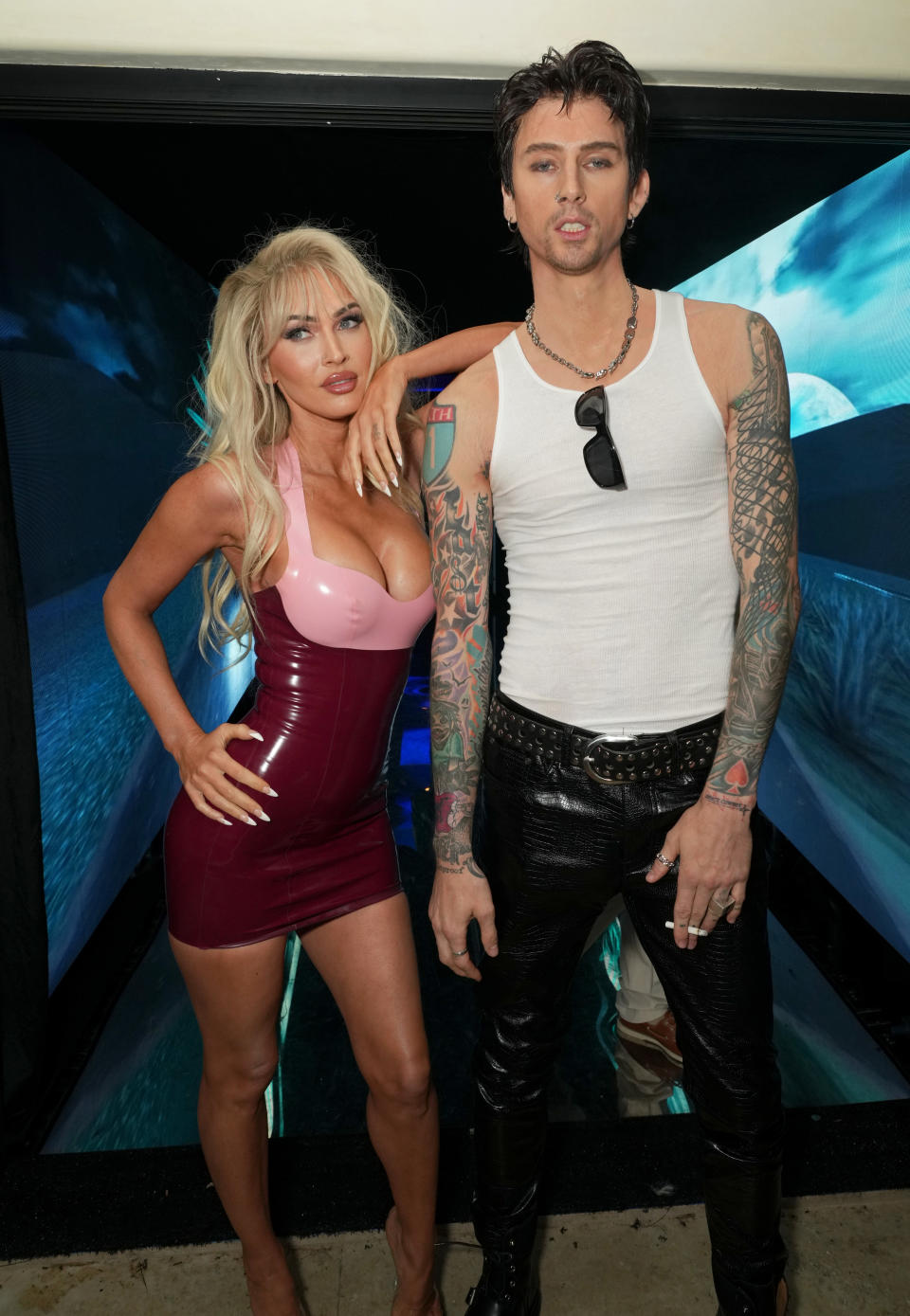 the two wearing outfits the real pamela and tommy wore with wigs and tattoos to complete the look