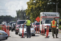 Members of law enforcement work with the National Guard to direct traffic onto U.S. Highway 501 as Hurricane Florence approaches the East Coast Wednesday, Sept. 12, 2018, near Conway, S.C. Time is running short to get out of the way of Hurricane Florence, a monster of a storm that has a region of more than 10 million people in its potentially devastating sights. (AP Photo/Sean Rayford)