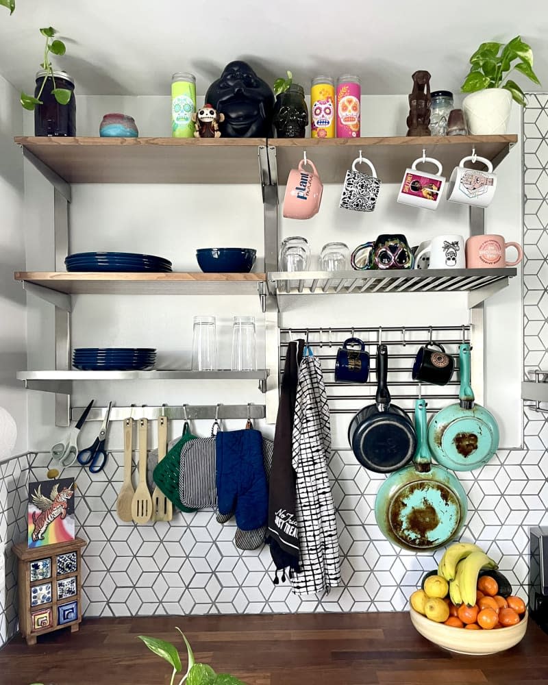 kitchen open shelves with lots of storage hooks and racks