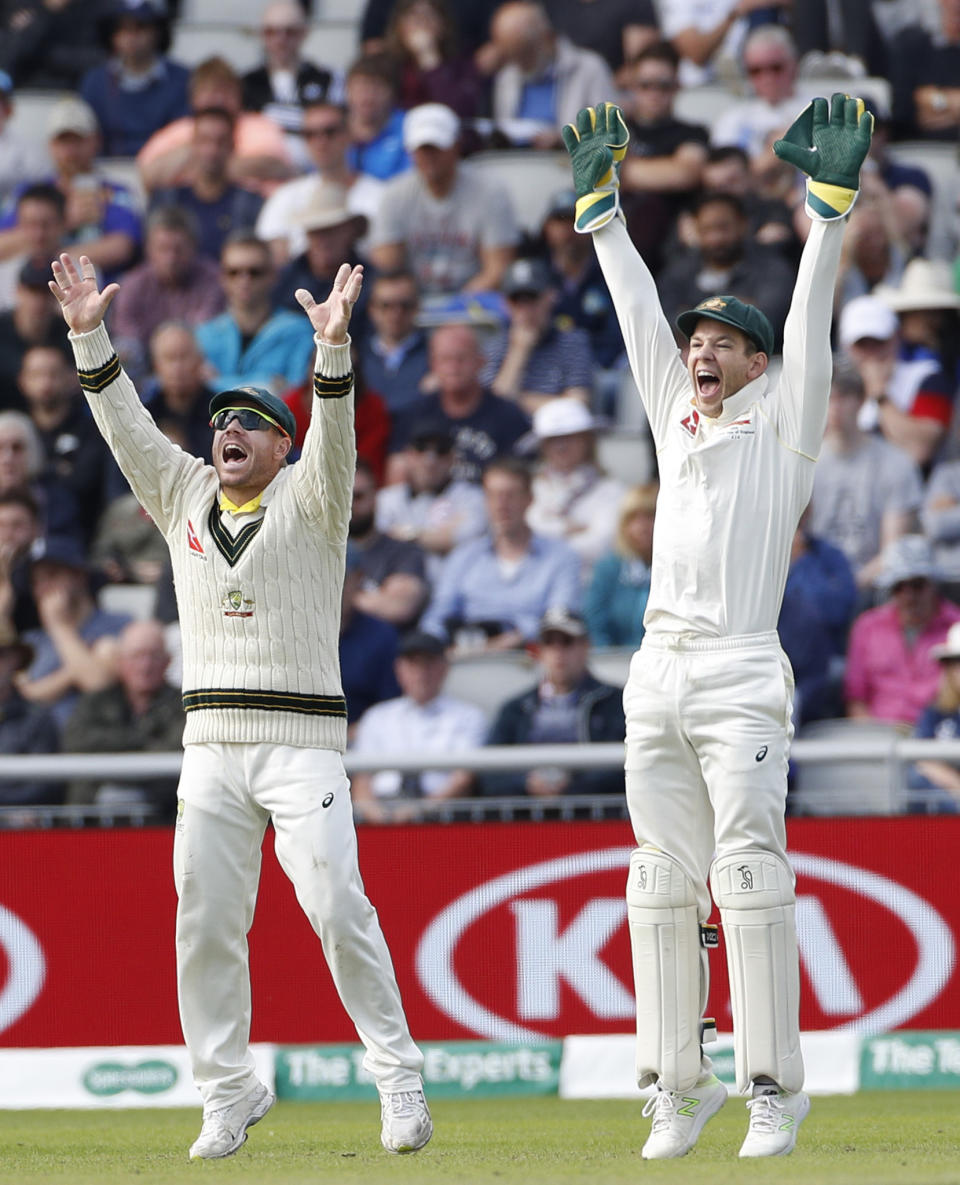 Australia's captain Tim Paine, right, and Australia's David Warner react during day five of the fourth Ashes Test cricket match between England and Australia at Old Trafford in Manchester, England, Sunday Sept. 8, 2019. (AP Photo/Rui Vieira)