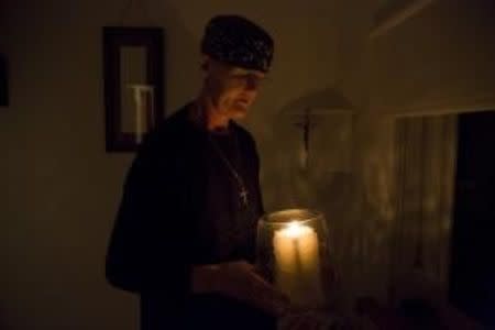 Sister Rachel Denton holds a candle during the Compline, or night prayers, at St Cuthbert's Hermitage in Lincolnshire, north east Britain September 25, 2015. REUTERS/Neil Hall