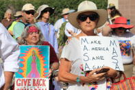 <p>Paula Vallejos of Albuquerque listens to speakers during a protest on Civic Plaza in downtown Albuquerque, N.M., on Saturday, June 30, 2018. Vallejos, who has been protesting since the 1960s, was among thousands who gathered on the plaza to voice concerns about everything from immigration policies to women’s rights. (Photo: Susan Montoya Bryan/AP) </p>