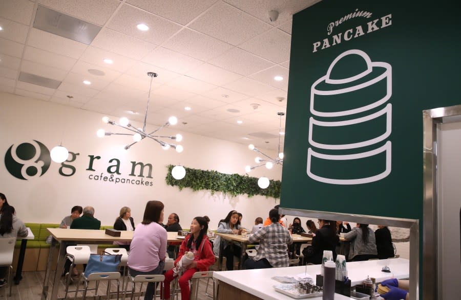 Customers sit at Gram Cafe and Pancakes in the Stonestown Galleria in San Francisco on April 18, 2019. This is the first Gram Cafe to open in the United States. People sometimes line up for hours to try the premium pancakes at the new Gram Cafe and Pancakes. The fluffy and wobbly soufflé pancakes are made three times a day and only 30 servings per time slot. (Photo by Justin Sullivan/Getty Images)