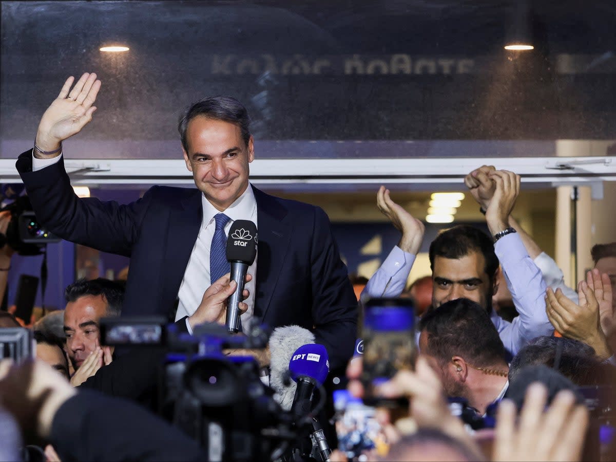 Greek prime minister and New Democracy conservative party leader Kyriakos Mitsotakis waves outside the party's headquarters, after the general election, in Athens, Greece (REUTERS)