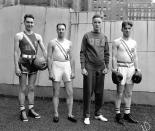 Official uniforms for U.S. athletes in the Olympic Games at Berlin, shown at sporting goods house, A.G. Spalding & Co. in New York on July 5, 1936. Left to right: uniforms for basketball, track, yachting and boxing. (AP Photo)