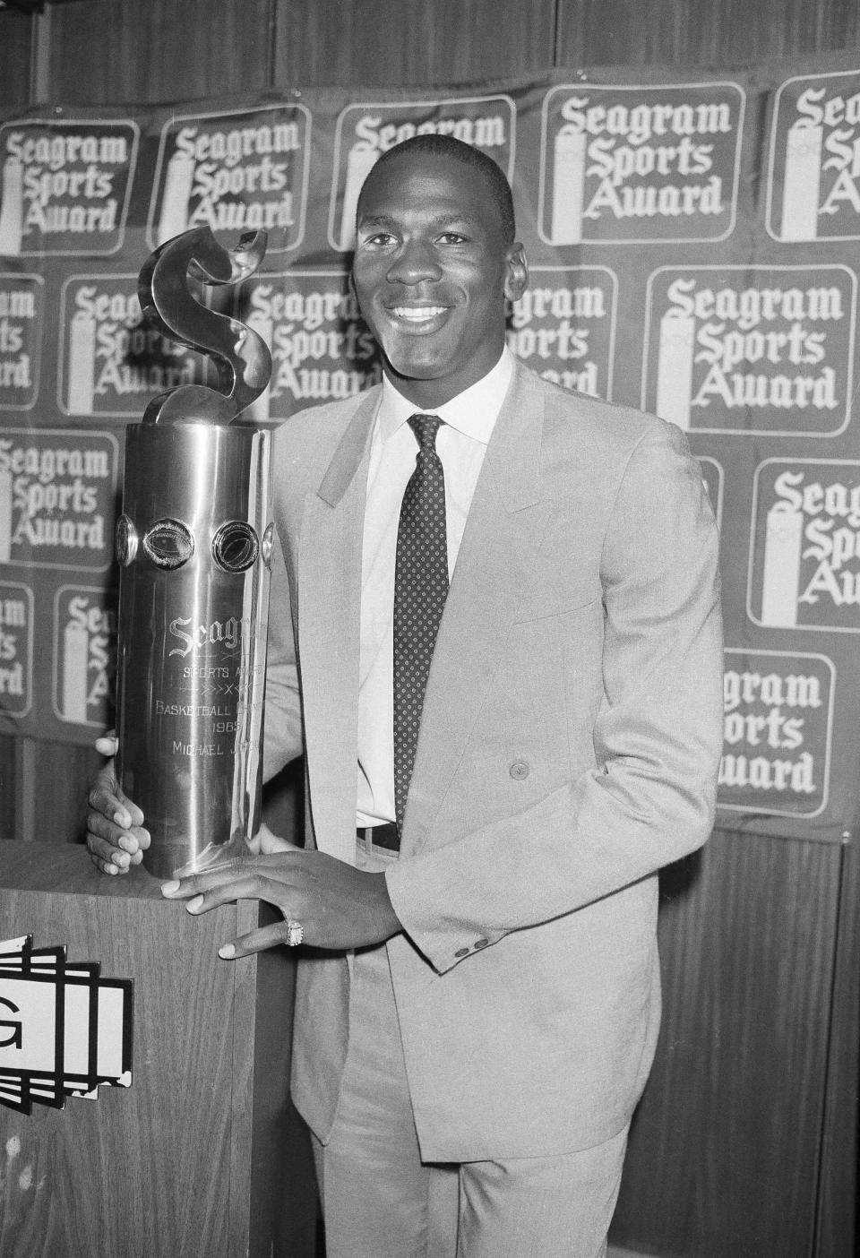 Michael Jordan smiles after receiving the Seagram Award after his rookie season at Madison Square Garden in New York, May 15, 1985. (AP Photo/G. Paul Burnett)