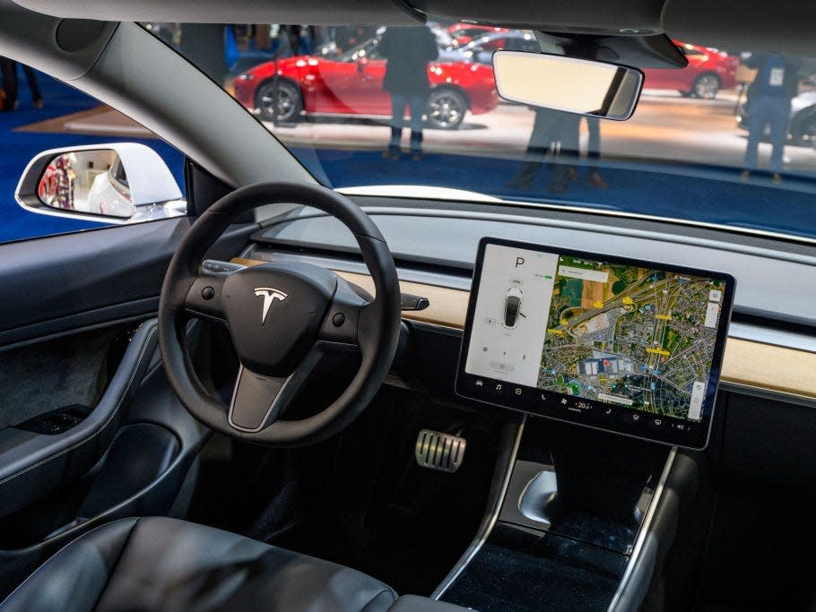 Tesla Model 3 compact full electric car interior with a large touch screen on the dashboard on display at Brussels Expo on JANUARY 09, 2020 in Brussels, Belgium. The Model 3 is fitted with a full self-driving system.