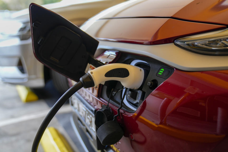 An electric car gets charged at a supermarket carpark in Sydney, Australia, Tuesday, Nov. 9, 2021. Australia’s prime minister on Tuesday announced plans to encourage people to buy electric vehicles weeks after his government was accused at a U.N. conference in Scotland of being a laggard in fighting climate change. (AP Photo/Mark Baker)