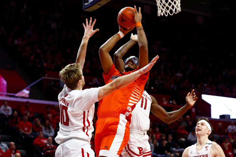 Andre Screen #23 of the Bucknell Bison attempts a shot as Cam Spencer #10 and Clifford Omoruyi #11 of the Rutgers Scarlet Knights defend during the first half of a game at Jersey Mike's Arena on December 23, 2022 in Piscataway, New Jersey.