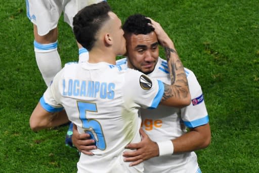 Marseille skipper Dimitri Payet is comforted by Lucas Ocampos as he comes off injured in the first half