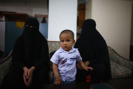 Uighur refugees wait during an interview with Reuters in Istanbul, Turkey, July 16, 2015. REUTERS/Osman Orsal