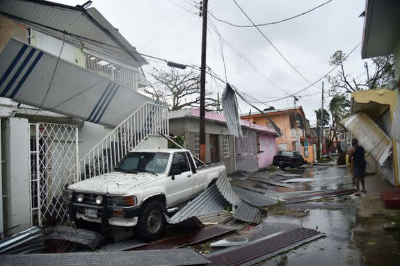 Residents of San Juan, Puerto Rico, deal with damages to their homes on September 20, 2017, as Hurricane Maria batters the island.