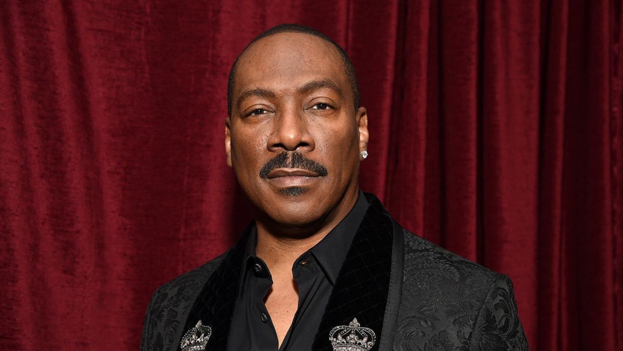 Actor Eddie Murphy sports black paisley print blazer