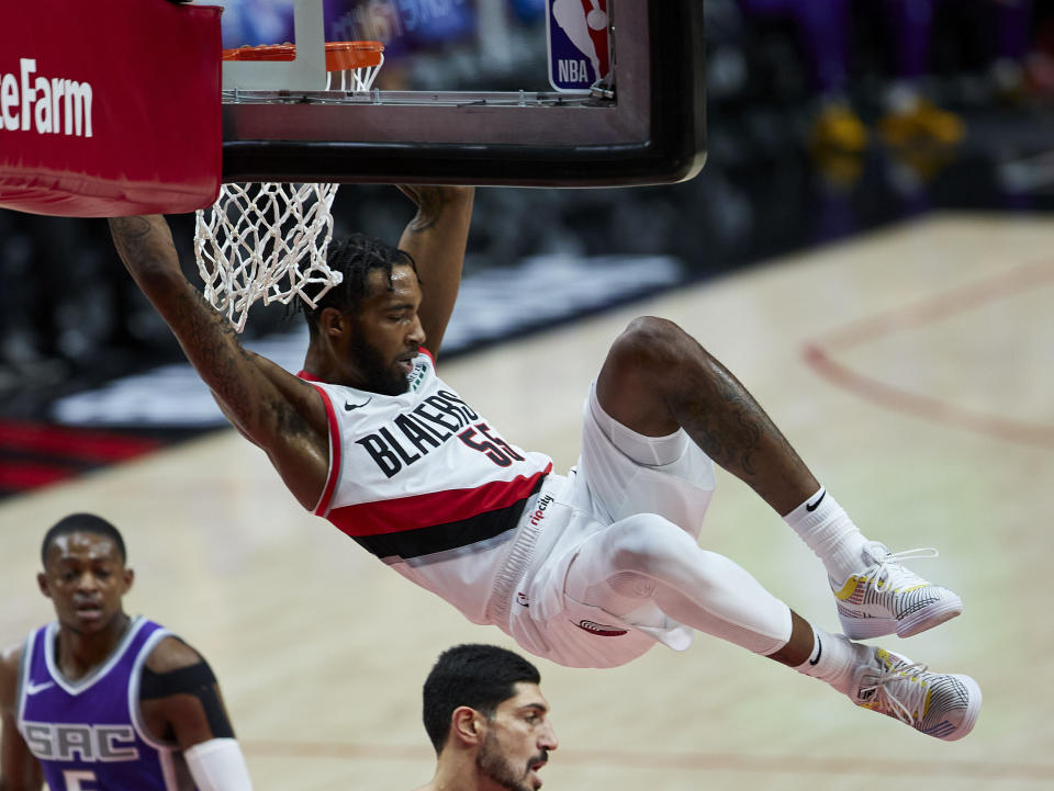 Portland Trail Blazers forward Derrick Jones Jr. dunks against the Sacramento Kings during the first half of a preseason NBA basketball game in Portland, Ore., Friday, Dec. 11, 2020. (AP Photo/Craig Mitchelldyer)