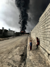 <p>Sebastian Tomada took the grand prize for this vivid snap of smoke bellowing from an oil well attacked by Islamic State militants in Qayyarah, Iraq. (Picture: IPP) </p>