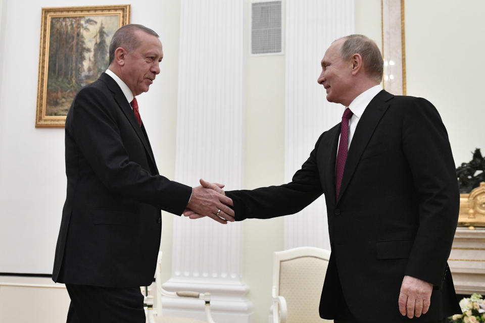 Russian President Vladimir Putin, right, shakes hands with Turkey's President Recep Tayyip Erdogan prior to their talks in the Kremlin in Moscow, Russia, Wednesday, Jan. 23, 2019. (Alexander Nemenov/Pool Photo via AP)