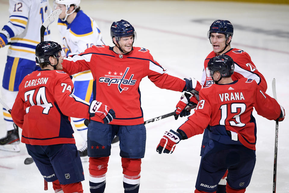 Washington Capitals center Nic Dowd (26) celebrates his goal with defenseman John Carlson (74), left wing Jakub Vrana (13) and right wing Garnet Hathaway (21) during the second period of an NHL hockey game against the Buffalo Sabres, Friday, Jan. 22, 2021, in Washington. (AP Photo/Nick Wass)