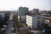 The headquarters building of the Arche, or Ark, an organization that supports children, youth and families, stand between residential buildings in the Hellersdorf neighbourhood, on the eastern outskirts of Berlin, Germany, Tuesday, Feb. 23, 2021. Since the outbreak of the coronavirus pandemic, the Arche has had to reduce their real face-to-face assistance or traditional classroom schooling as an offer for children, mainly from underprivileged families, drastically. Some kids are still allowed to come over in person, but only once every two weeks. (AP Photo/Markus Schreiber)