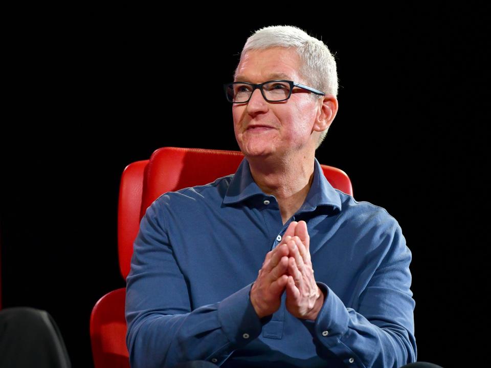 Tim Cook Apple sitting on a red chair