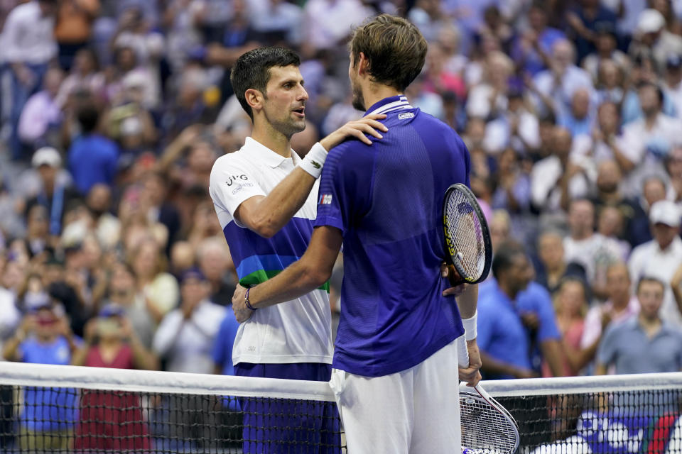 Novak Djokovic, of Serbia, left, congratulates Daniil Medvedev, of Russia, after Medvedev won the men's singles final of the US Open tennis championships, Sunday, Sept. 12, 2021, in New York. (AP Photo/John Minchillo)