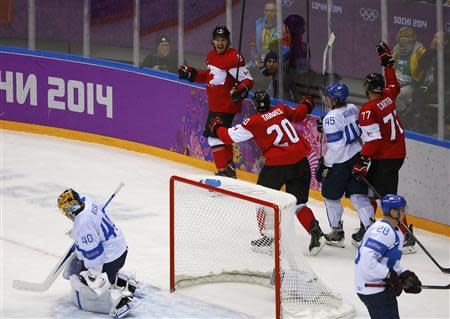 Canada's Drew Doughty (top) celebrates after scoring the game winning overtime goal against Finland's goalie Tuukka Rask (40) with Canada's John Tavares (20) and Jeff Carter (77) as Finland's Lauri Korpikoski (bottom, R) and Finland's Sami Vatanen (45) react during the overtime period of their men's preliminary round ice hockey game at the Sochi 2014 Winter Olympic Games February 16, 2014. REUTERS/Brian Snyder