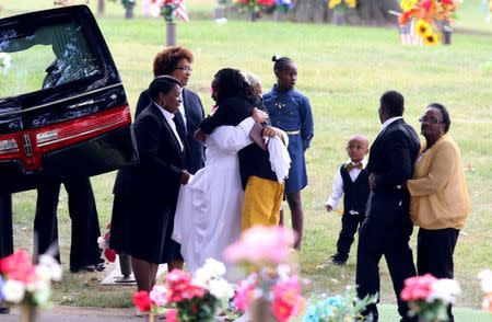 Mourners stand at the cemetery during the funeral of Tyre King, a 13-year-old African-American youth shot last week by a white police officer, in Columbus, Ohio, September 24, 2016. REUTERS/Aaron Josefczyk