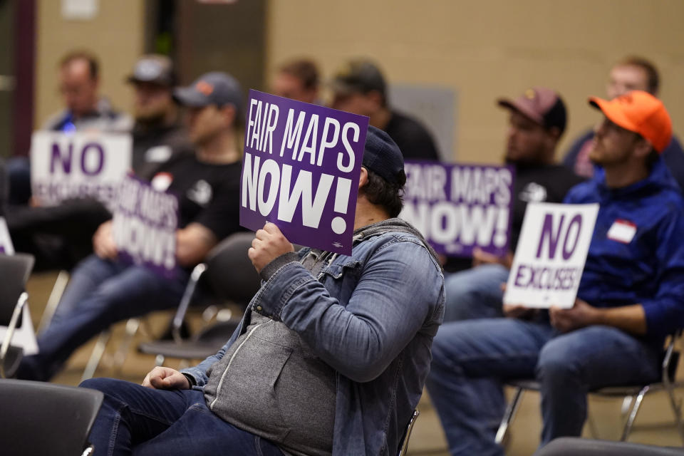 Protesters attend a meeting of Michigan's new Independent Citizens Redistricting Commission on Oct. 21, 2021, in Lansing, Mich. The attendees were not in favor of putting majority-Black neighborhoods districts in other districts, where they may have more say over Michigan's leadership. (AP Photo/Carlos Osorio)