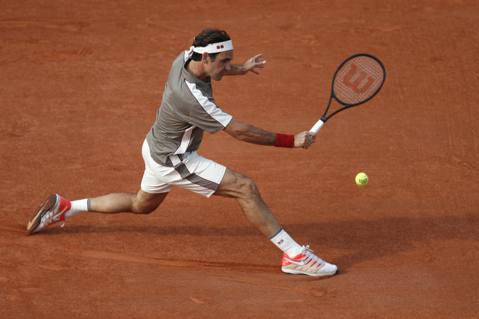 FILE- In this Tuesday June 4, 2019, image, Switzerland's Roger Federer plays a shot against Switzerland's Stan Wawrinka during their quarterfinal match of the French Open tennis tournament at the Roland Garros stadium in Paris. The skill of sliding at Roland Garros is on hold at the moment with the start of the French Open postponed until September because of the coronavirus, but sliding will still be one of the keys to success at the French Open whenever it is played. Federer returned to clay-court tennis in 2019, a decade after his French Open title with his confidence low, he explained, “because I don’t even remember how to slide anymore.” (AP Photo/Jean-Francois Badias, File)