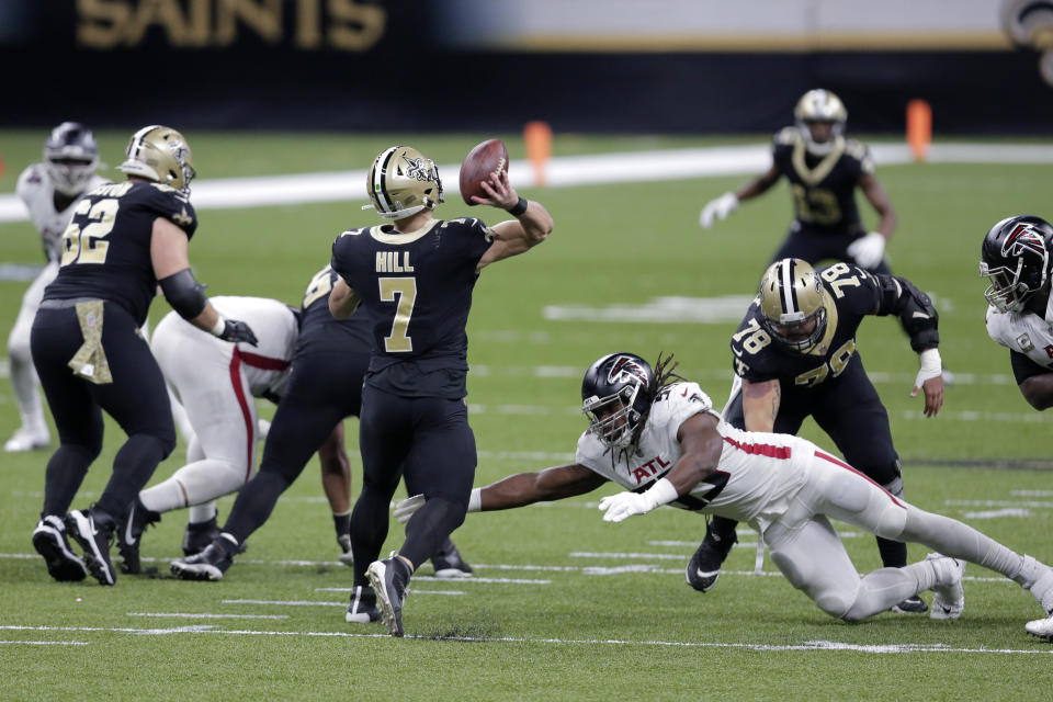 New Orleans Saints quarterback Taysom Hill (7) passes under pressure from Atlanta Falcons defensive end Steven Means (55) in the first half of an NFL football game in New Orleans, Sunday, Nov. 22, 2020. (AP Photo/Brett Duke)