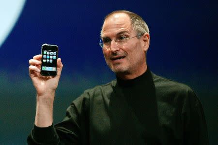 FILE PHOTO -- Apple Computer Inc. Chief Executive Officer Steve Jobs holds the new iPhone in San Francisco, California January 9, 2007. REUTERS/Kimberly White/File Photo