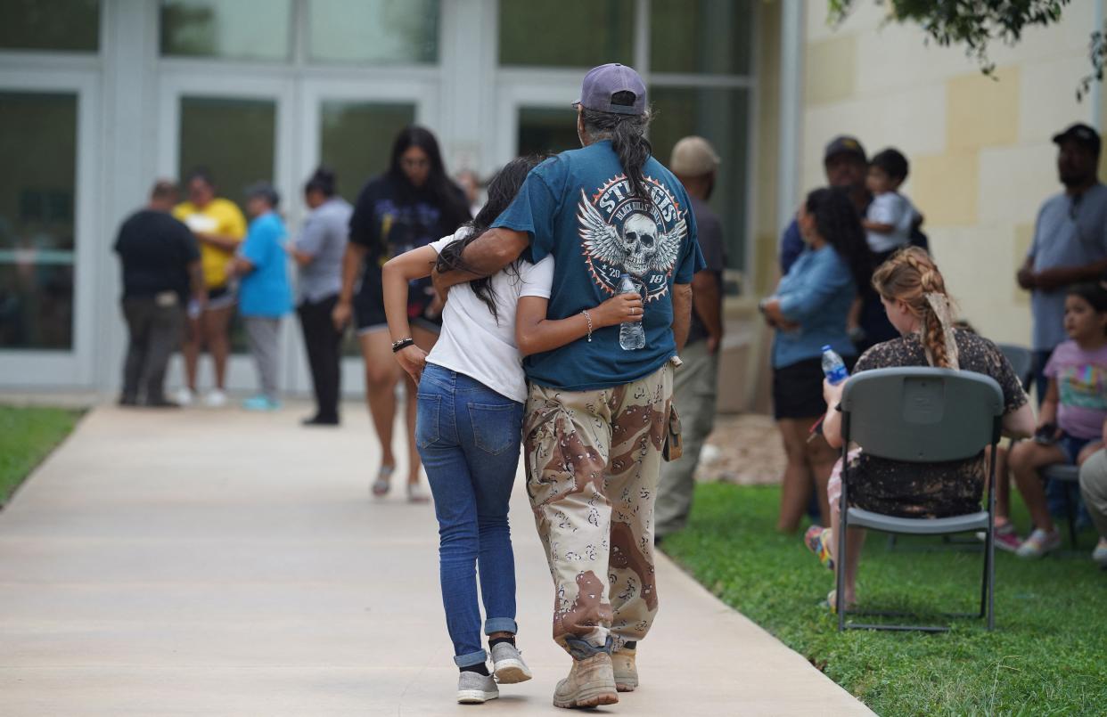 Families gather and hug outside the Willie de Leon Civic Center where grief counseling will be offered in Uvalde, Texas on May 24, 2022.