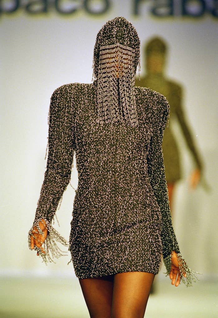 A model is partly hidden behind a top of a rib weave ensemble designed by Paco Rabanne for the fall/winter haute couture collection in Paris on July 26, 1989.