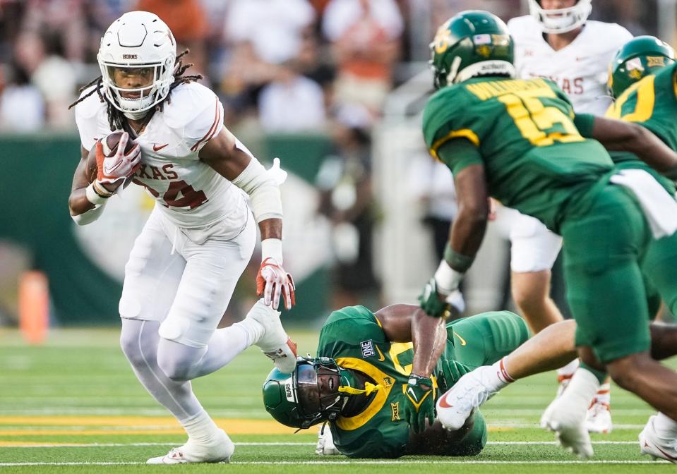 Texas running back Jonathon Brooks (24) looks for room to run against Baylor defense in the first quarter of an NCAA college football game, Saturday, Sept. 23, 2023, in Waco, <a class="link " href="https://sports.yahoo.com/ncaaf/teams/texas/" data-i13n="sec:content-canvas;subsec:anchor_text;elm:context_link" data-ylk="slk:Texas;sec:content-canvas;subsec:anchor_text;elm:context_link;itc:0">Texas</a>.