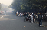 Students make their way after being evacuated from their residence at the University of Cape Town, South Africa, Sunday, April 18, 2021. A wildfire raging on the slopes of the mountain forced the evacuation and caused damage to several buildings as firefighters battled the blaze. (AP Photo/Nardus Engelbrecht)