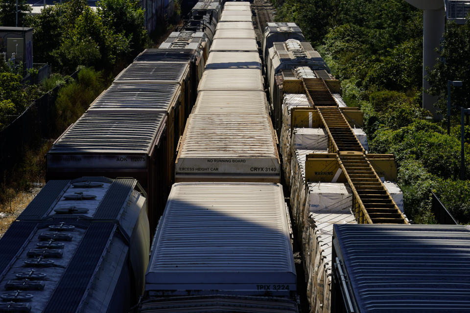 FILE - Freight train cars sit idle on tracks in Philadelphia, Wednesday, Sept. 14, 2022. Rail unions want railroads to take some of the billions they’re using every year to buy back their stock and use it to improve safety in the wake of several high-profile derailments and hire more workers. (AP Photo/Matt Rourke, File)