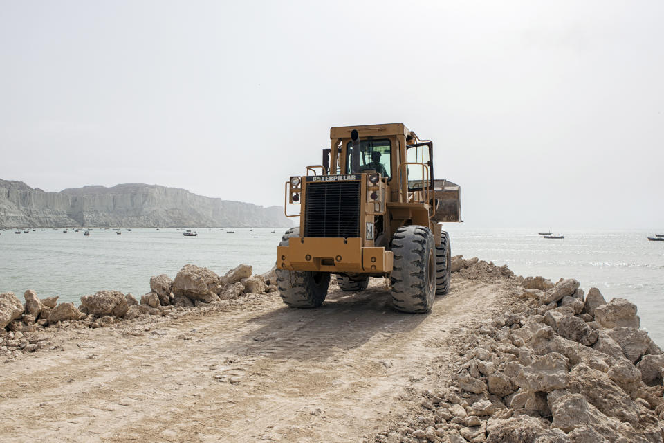 A bulldozer operates on a development site on Marine Drive in Gwadar, Balochistan, Pakistan. (Photo: Getty Images)