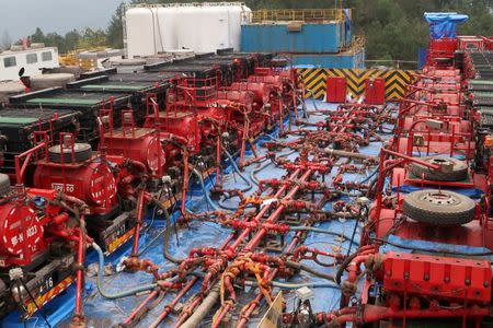 FILE PHOTO: Fracking trucks at work are seen at a shale gas well of Sinopec in Nanchuan, Chongqing, China March 18, 2018. REUTERS/Chen Aizhu/File Photo